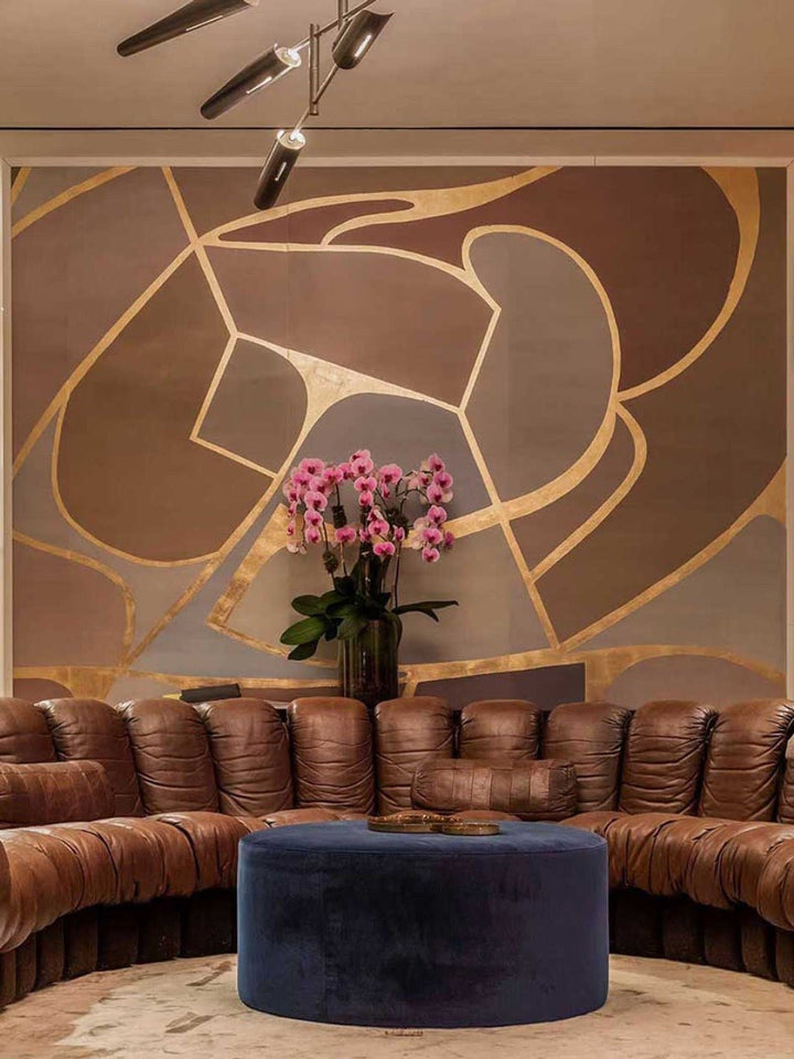 Aqualille Geo wallpaper in cool gold in a living room